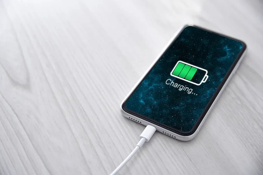 Teléfono móvil enchufado al cargador.